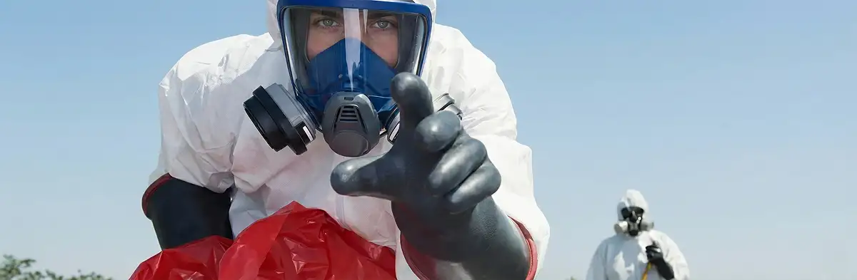 sewage clean up technician wearing protective gear handling biohazard materials in New Orleans, LA